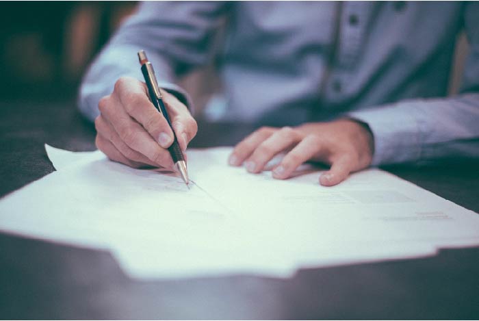 Man filling out forms on a desk